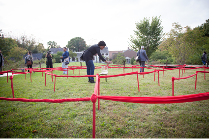 Multiple people inside maze made with red string