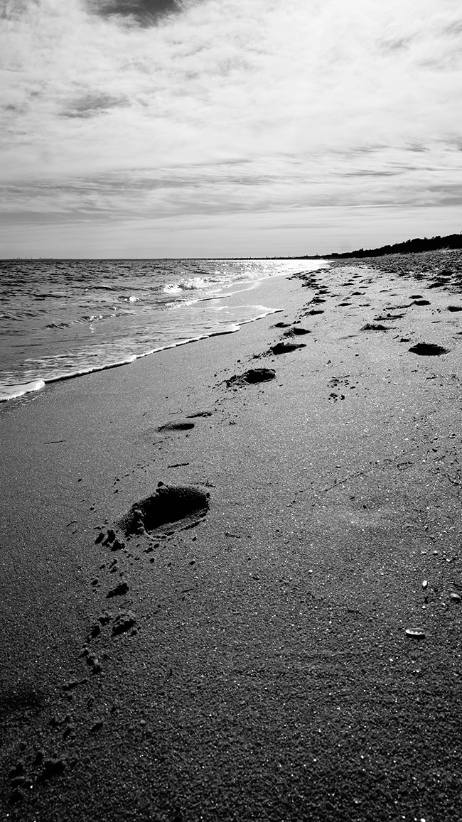 Footsteps in sand at beach