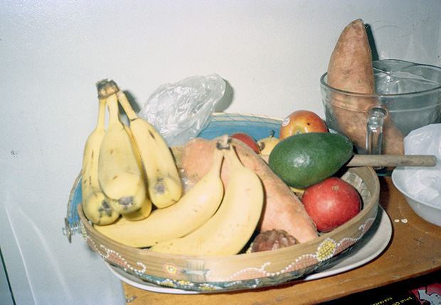 Image of fruit bowl with bananas, apples, an avocado and sweet poatatoes
